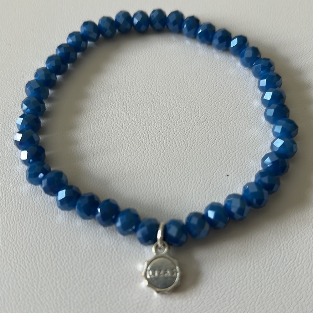 Lizas Bracelet Blue Faceted Beads and Silvertone Name Brand Charm